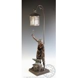 A French bronze speltre figural table lamp, modelled as a blacksmith at an anvil, on square base,