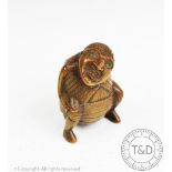A 19th century continental carved treen snuff box, modelled as a defecating man,