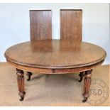 A Victorian oval oak extending dining table,