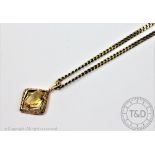 A citrine set 9ct gold pendant,