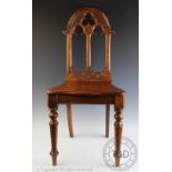 A Victorian walnut hall chair, with gothic arch back, 89cm high (back leg repaired),