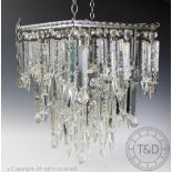 A chrome plated metal three tier ceiling light, of square form, hung with mixed cut lustres,