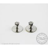 A pair of diamond set shirt studs, each set with a single brilliant cut diamond,