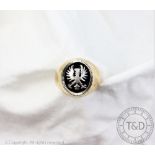A heavy yellow metal signet ring,