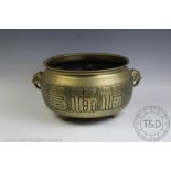 A large Chinese brass jardiniere of cauldron form,