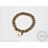 A yellow metal bracelet, stamped '15',