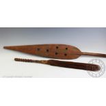 An African carved wood paddle, with an old passenger label for a Mr Evans travelling from Capetown,