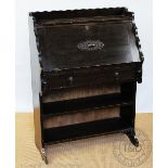 A 1920's stained oak students desk,
