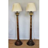 A pair of Arts and Crafts type carved and painted oak standard lamps (converted from jardinière