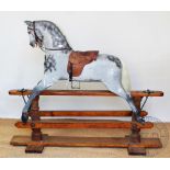 A Victorian wood and gesso rocking horse, with dappled grey detailing and leather saddle,