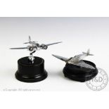 Two chrome car mascots in the form of aeroplanes, each mounted upon later plinth base,