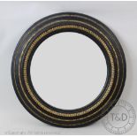 A Regency style gilt wood and gesso ebonised convex wall mirror, second half of the 19th century,