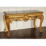 An impressive George II style carved gilt wood and gesso console table in the manner of William