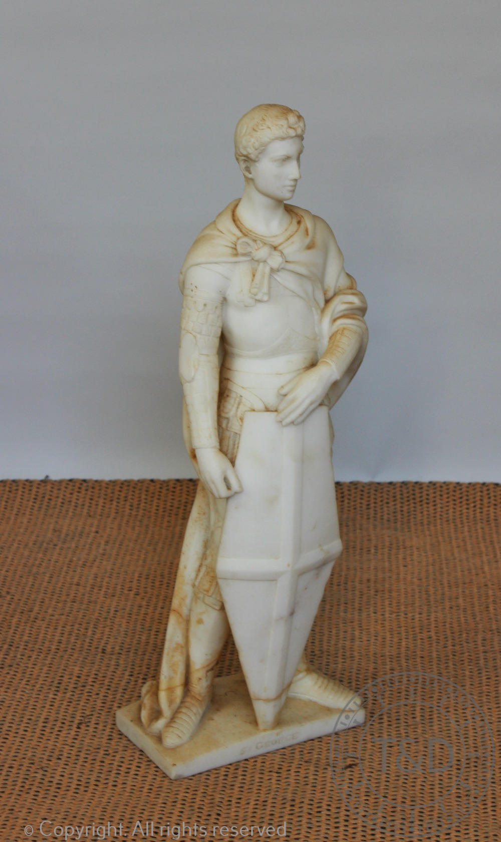 A 19th century carved alabaster figure of St George on rectangular base,