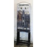 A vintage chromed metal and cast iron cigarette vending machine,