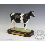 A Harper Shebeg Friesian Cow 'Kynarton Tong Sunray VG LP 120' upon plinth base,