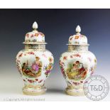A pair of Continental porcelain baluster vases and covers,