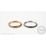 A white metal wedding band, with engraved floral design,