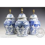 Three modern blue and white table lamps, modelled as vases and covers in the Chinese Kangxi style,