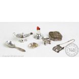 A selection of silver items, to include, a table lighter in the form of a genie's lamp,