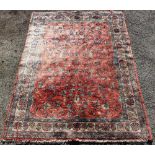 A wool carpet, worked with flowers against a red ground, 260cm x 160cm, with another wool rug,