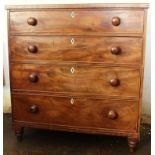 An early 19th century mahogany chest, of four graduated long drawers with ivory escutcheons,