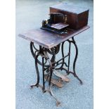 A Wheeler & Wilson vintage treadle sewing machine retaining a curved needle,