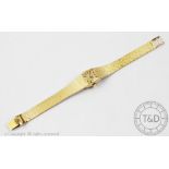 A ladies Longines 9ct gold wristwatch 1979, he cushion shaped face with gilt dial,