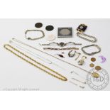 A selection of jewellery, to include, an oval locket and chain, a watch strap, assorted earrings,