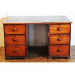 A late 19th century mahogany pedestal desk with six drawers, on bun feet,