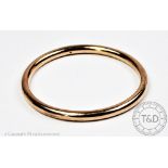 A 9ct yellow gold Smith and Pepper 'slave' bangle, of plain polished, simple design,