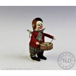 A Schuco clockwork clown drummer, with key wind mechanism,