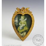 A French late 19th century gilt metal heart shaped photograph frame, with easel back,