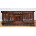 A late 19th century carved oak ecclesiastical panel, with aumbry box decorated with the eucharist,