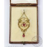 An early 20th century tourmaline and seed pearl set pendant within fitted case,