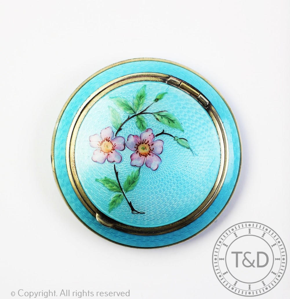 A white metal and turquoise blue enamel circular compact,