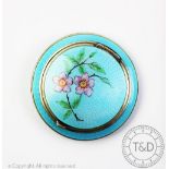A white metal and turquoise blue enamel circular compact,