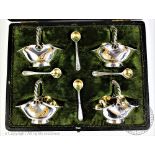 A set of four Walker and Hall silver plated and gilt condiments,