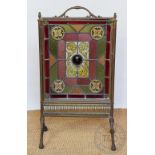 A Victorian stained glass and brass fire screen,