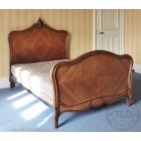 A French walnut small double bed, in Louis XV style, 152cm H x 147cm W x 208cm long (approx).