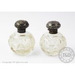 A pair of late Victorian silver mounted cut glass scent bottles and stoppers, Birmingham 1900,