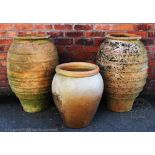 A large pair of terracotta garden urns, 82cm H, with a smaller urn,