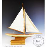 A 1950's model pond yacht named 'Seagull', with half painted hull, 68cm long, 71cm high,
