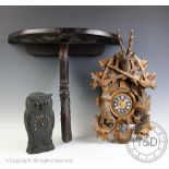A 20th century German cuckoo clock, with stag surmount and hanging game, with weights and pendulum,