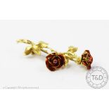 An 18ct yellow gold rose spray and enamelled brooch,