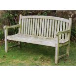 A garden bench, with curved back,