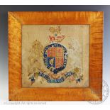 A 19th century needlework panel of The Royal Coat of Arms of the United Kingdom, within maple frame,