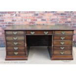 A 19th century mahogany partners desk, with leather inset top above eleven drawers to either side,
