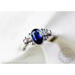 An untested sapphire and diamond ring, the central oval, untested sapphire (measuring approx 8.