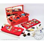 A red jewellery box containing a quantity of assorted vintage and costume jewellery,